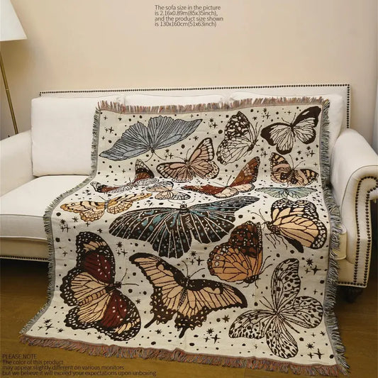 Manta decorativa con borlas y diseño de mariposas